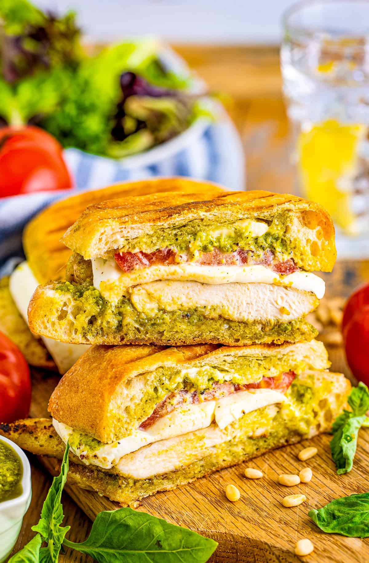 Finished Pesto Chicken Sandwich cut in half and stacked on top of one another.
