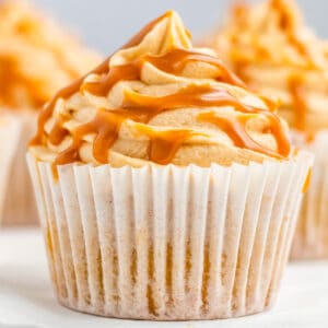 Close up square image of finished cupcake frosted and drizzled with salted caramel.