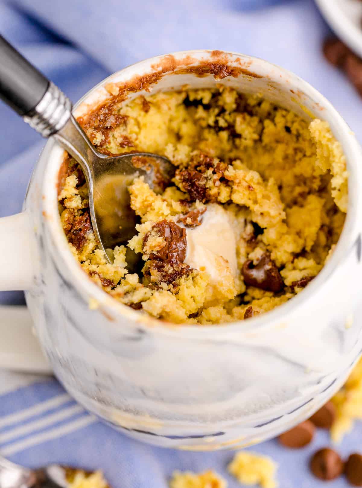 Close up of Chocolate Chip Mug Cake with some scoops removed showing inside with some ice cream.