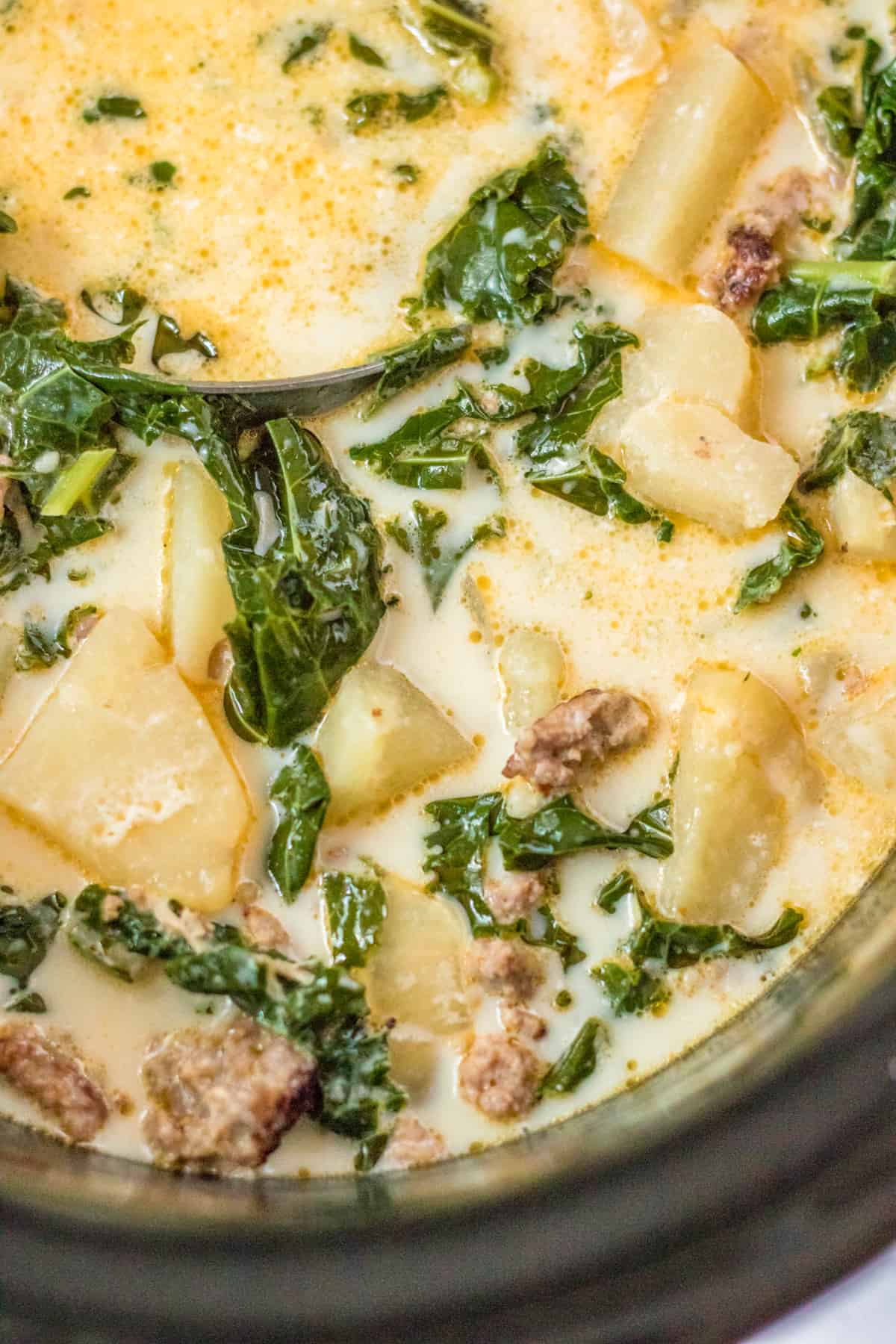 Overhead close up photo of Slow Cooker Zuppa Toscana in slow cooker.