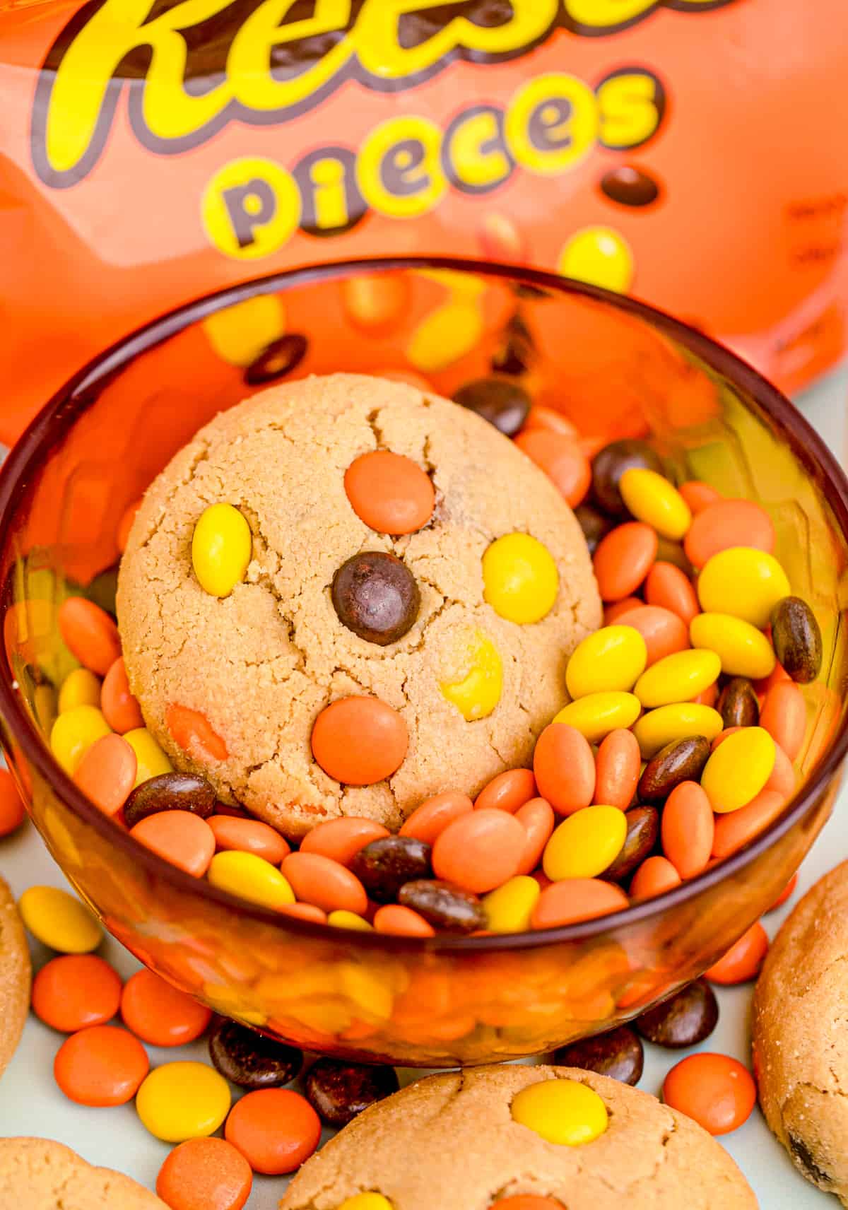 One cookie in a bowl of Reese's Pieces.