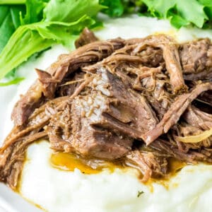 Close up square image of beef on mashed potatoes.