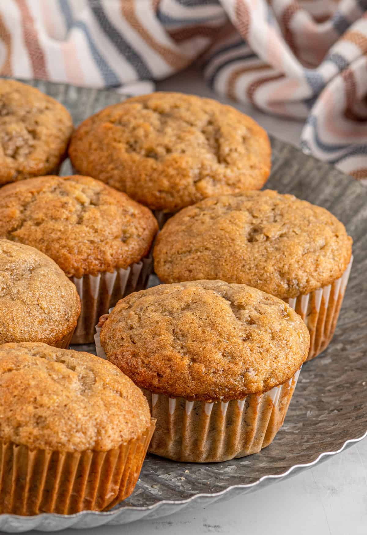 Close up side view of Easy Banana Muffins on galvanized metal plate.