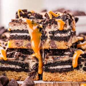 Close up square image of stacked bars drizzled with caramel sauce.