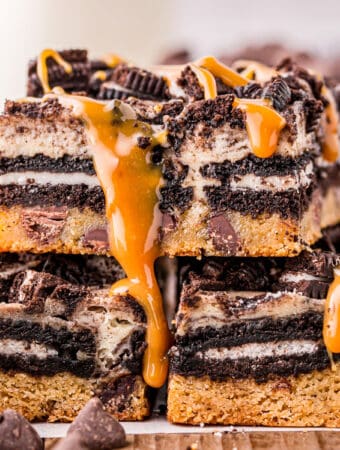 Close up square image of stacked bars drizzled with caramel sauce.