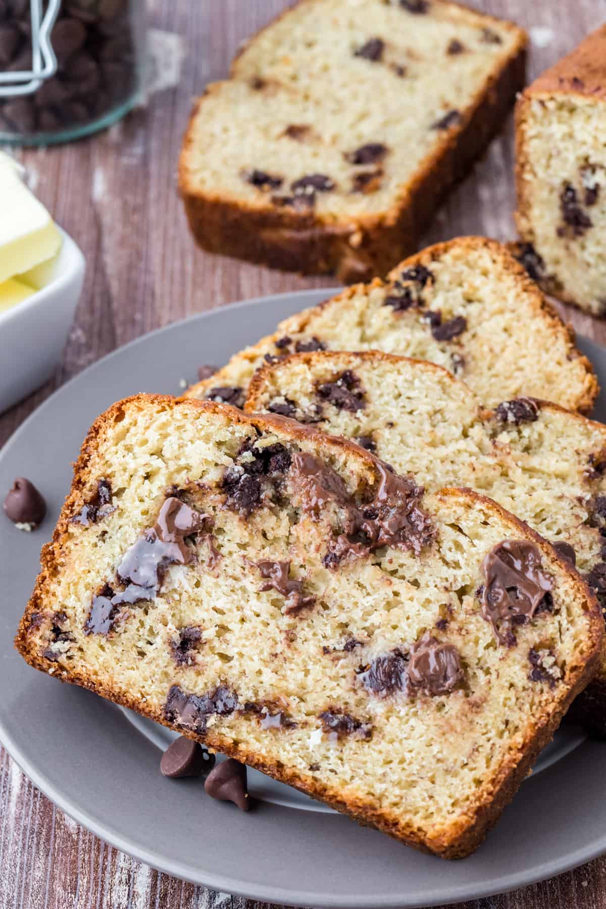 Slices of Chocolate Chip Banana Bread on grey plate showing melted chocolate chips.