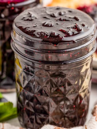 Close up square image of jam in mason jar.