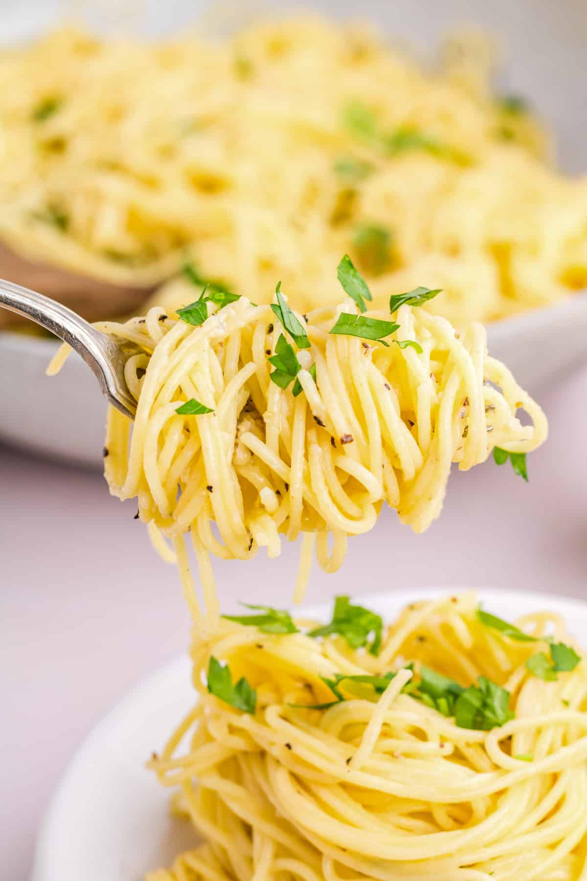 Fork with pasta swirled around it.