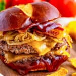 Close up square image of burger showing all the layers and ingredients.