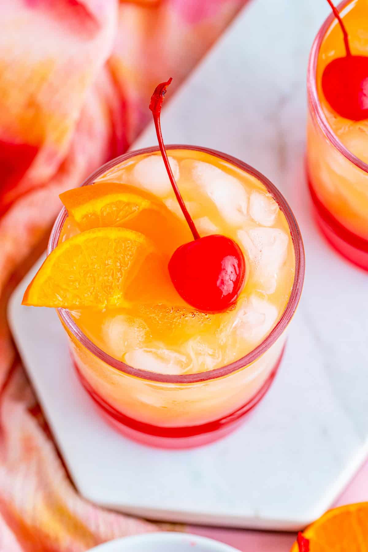 Overhead of finished drink showing off the orange and cherry garnish.