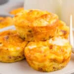 Close up square image of stacked bites on white plate.