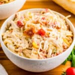 Close up square image of spaghetti in white bowl.
