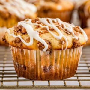 Close up square image of one muffin glazed on wire rack.