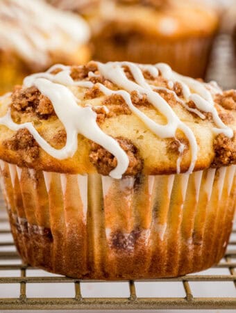 Close up square image of one muffin glazed on wire rack.