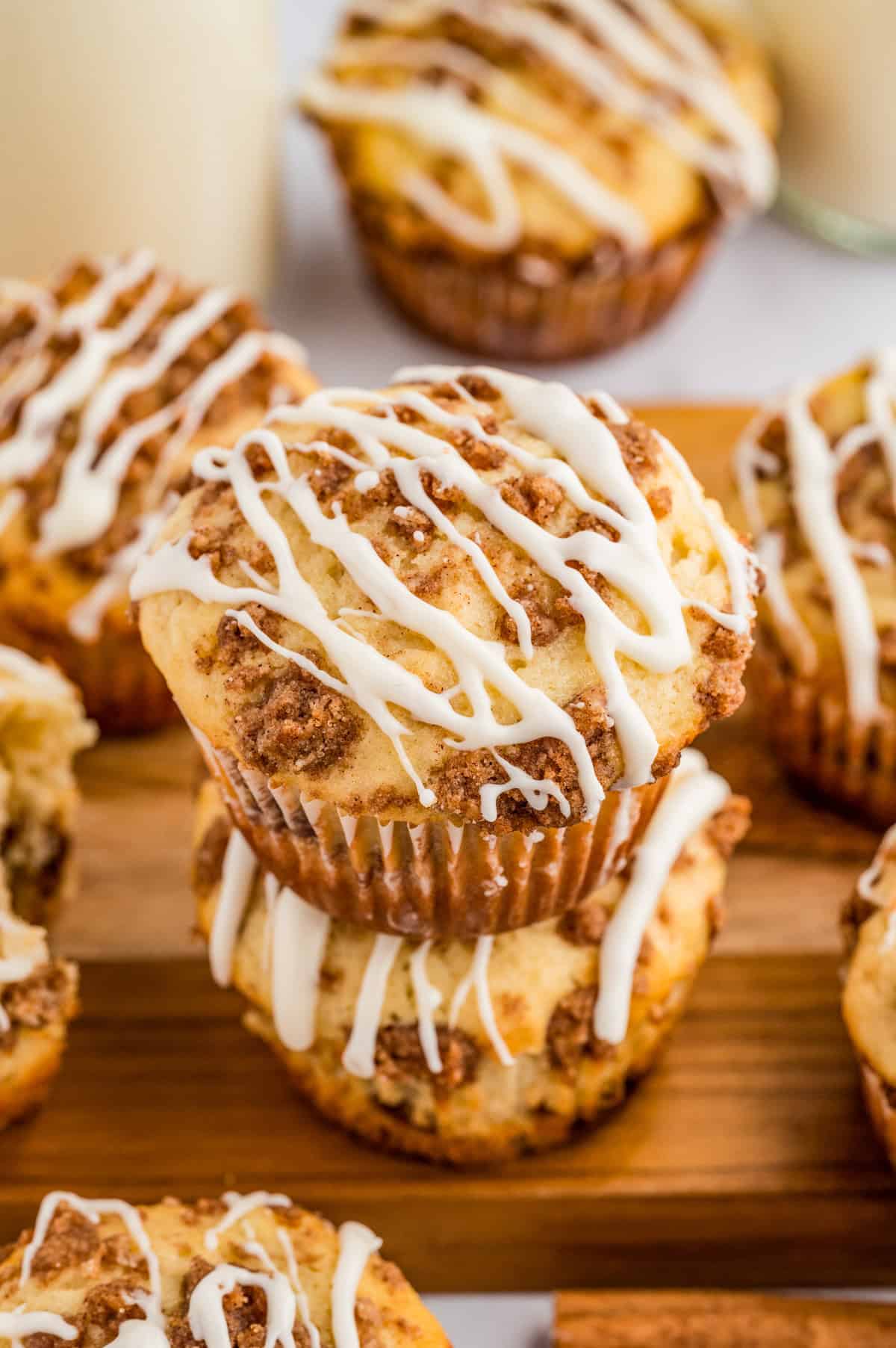 Two stacked muffins on wooden board showing the streusel topping.