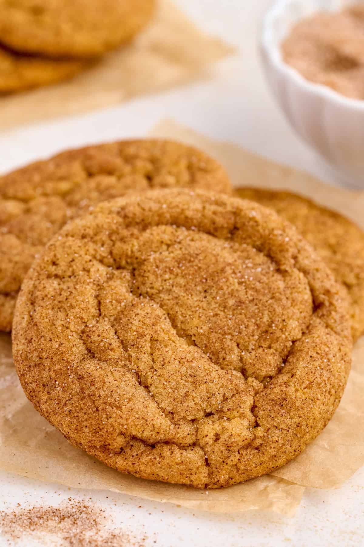 Finished Pumpkin Snickerdoodles resting on one another showing off the cinnamon sugar outside.