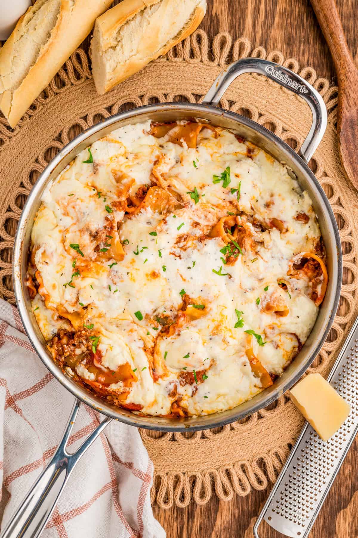 Overhead of finished lasagna in skillet topped with basil.