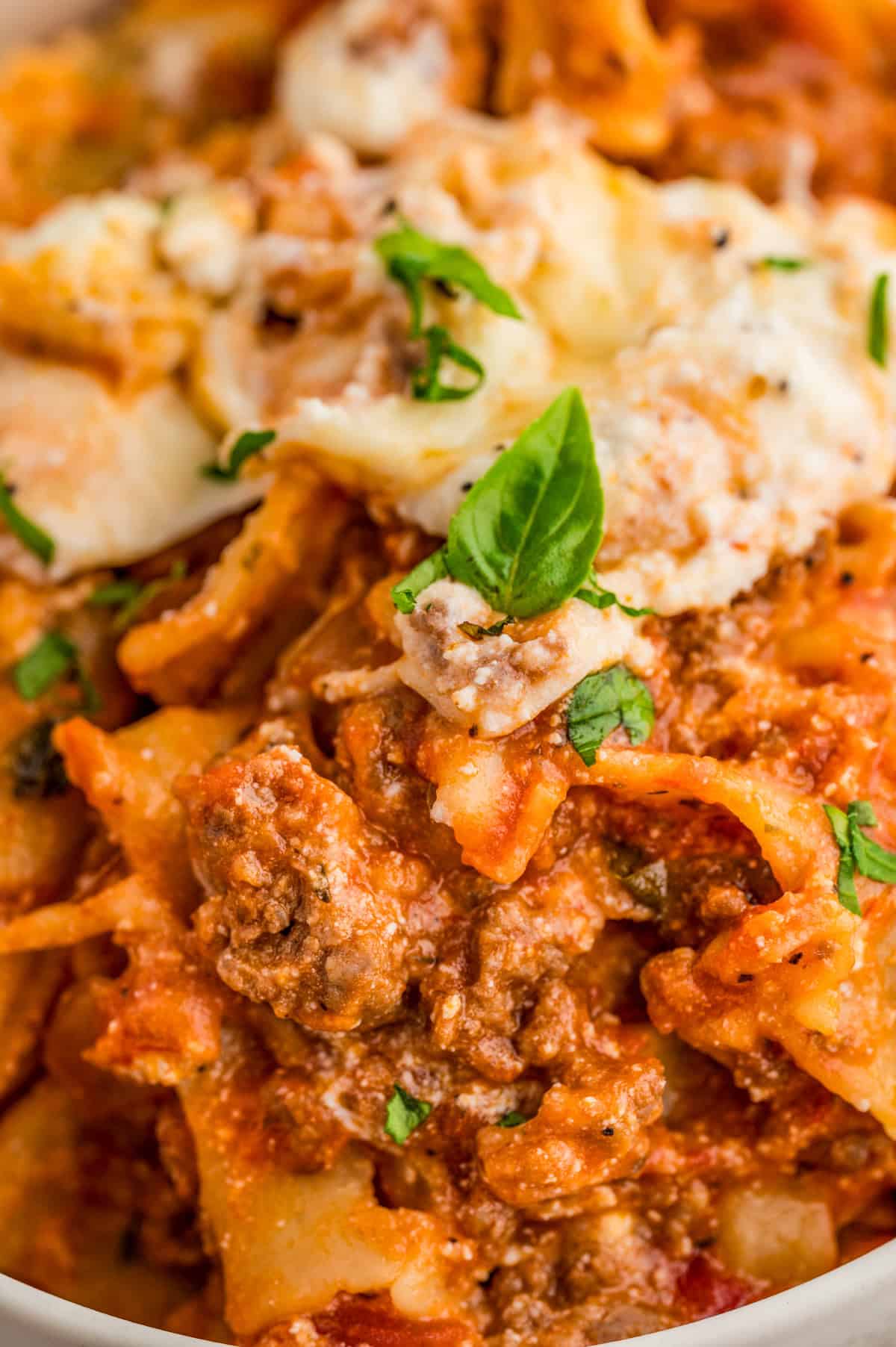 Very close up of lasagna showing the meat, cheese and noodles.