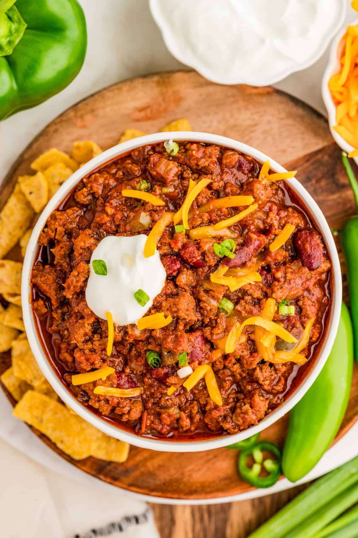 Overhead of chili in white bowl showing off the toppings.