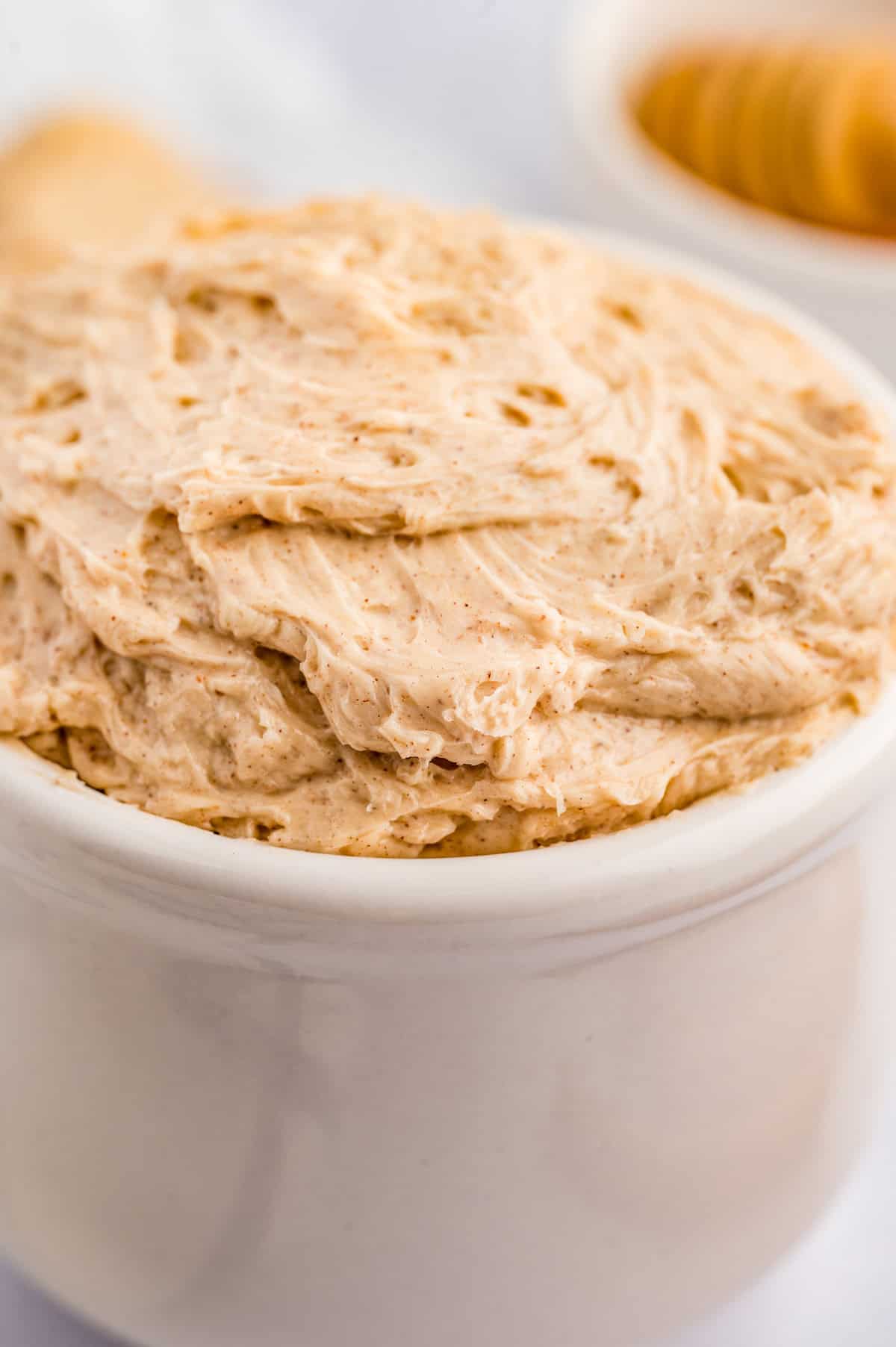 Close up of butter in white bowl.