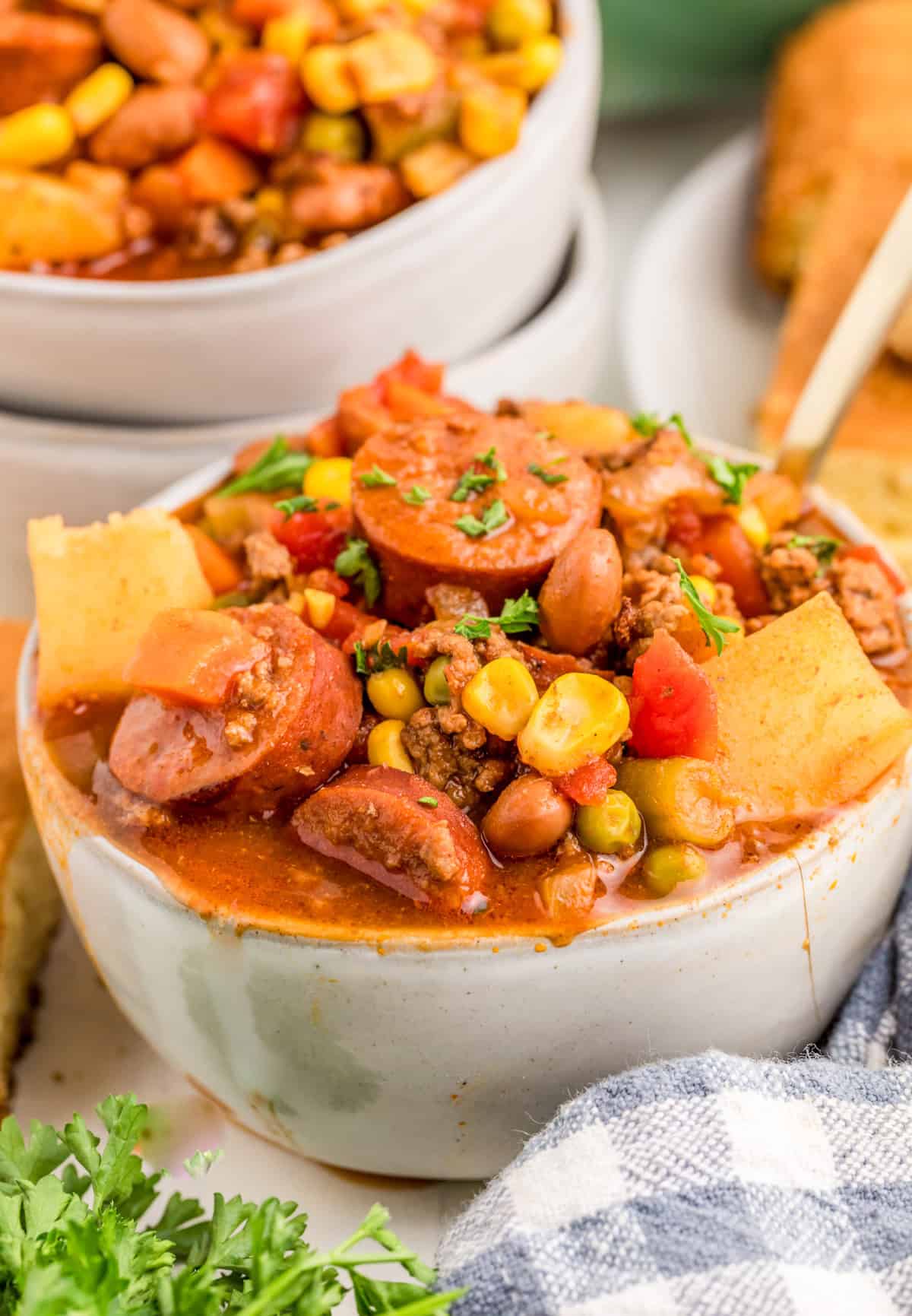 Cowboy Stew in bowl with spoon with another bowl of stew behind it.