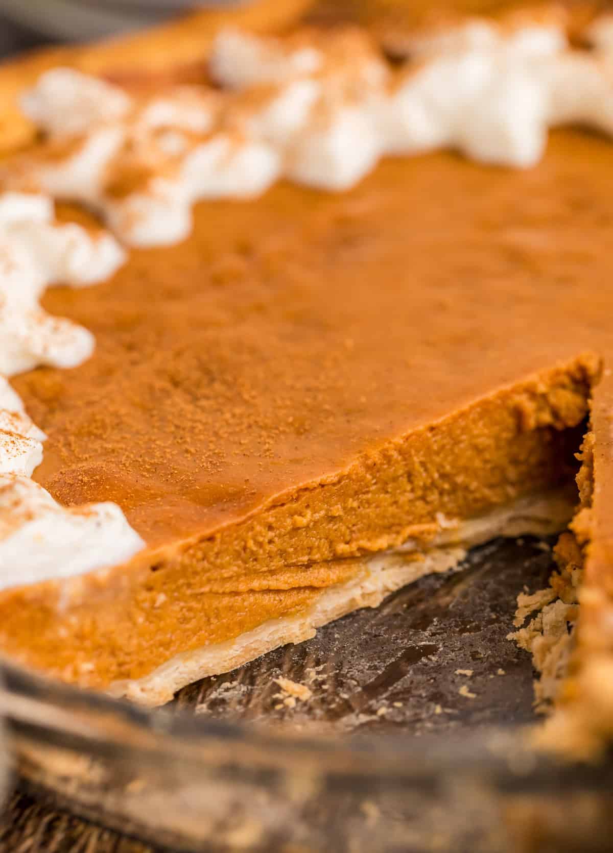 Pie in pie plate with a slice removed showing the inside of pie.