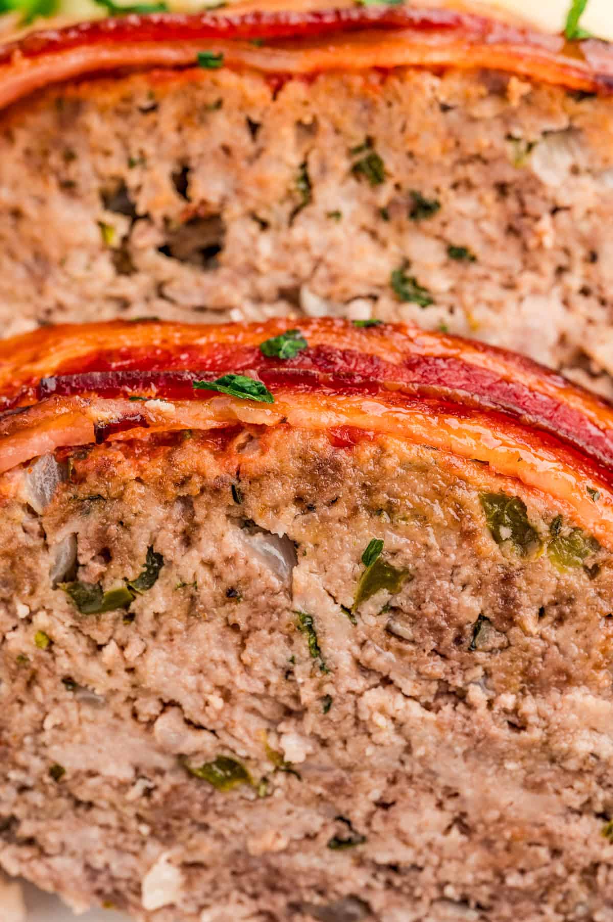 Close up of meatloaf showing the texture and bacon.