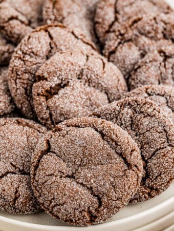 Close up of cookies layered on a white plate.