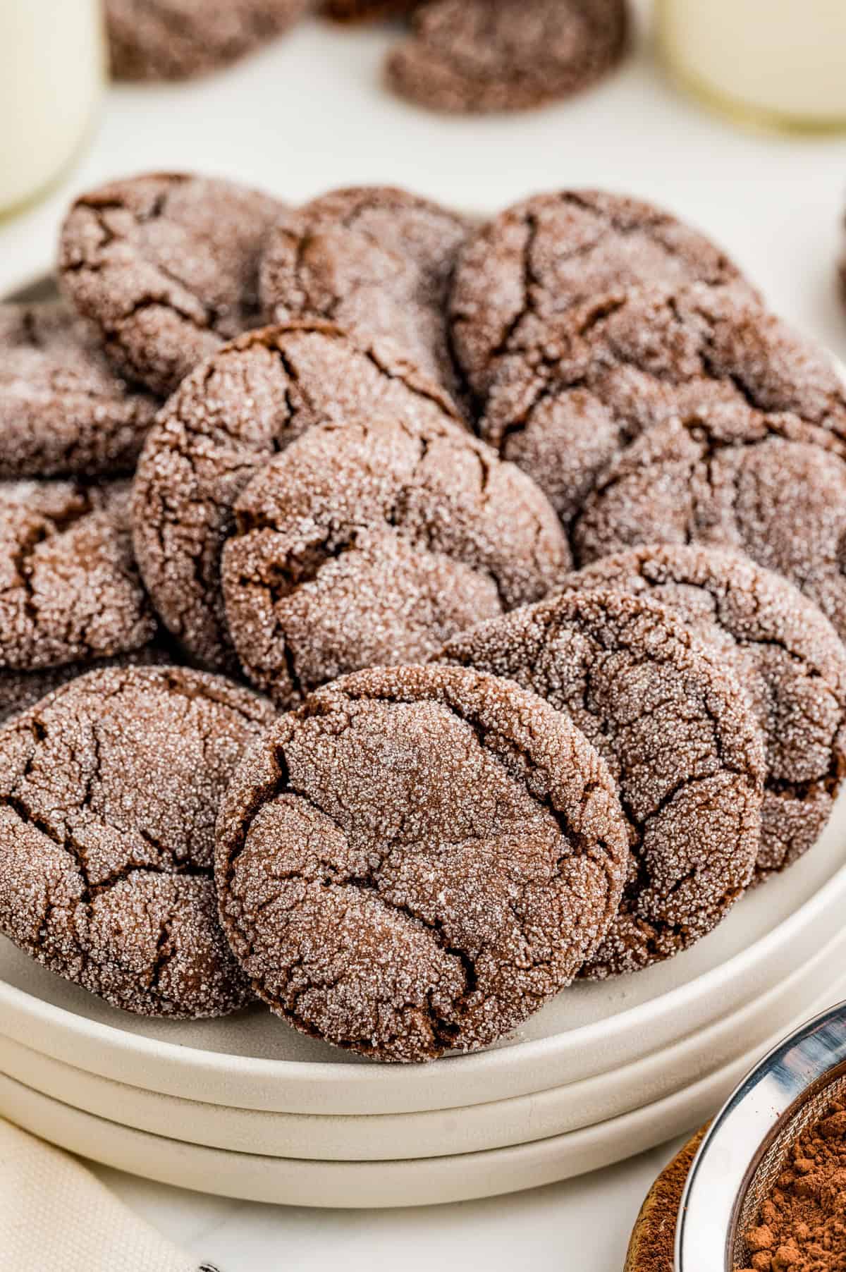 Chocolate Sugar Cookies layered on stacked white plates.