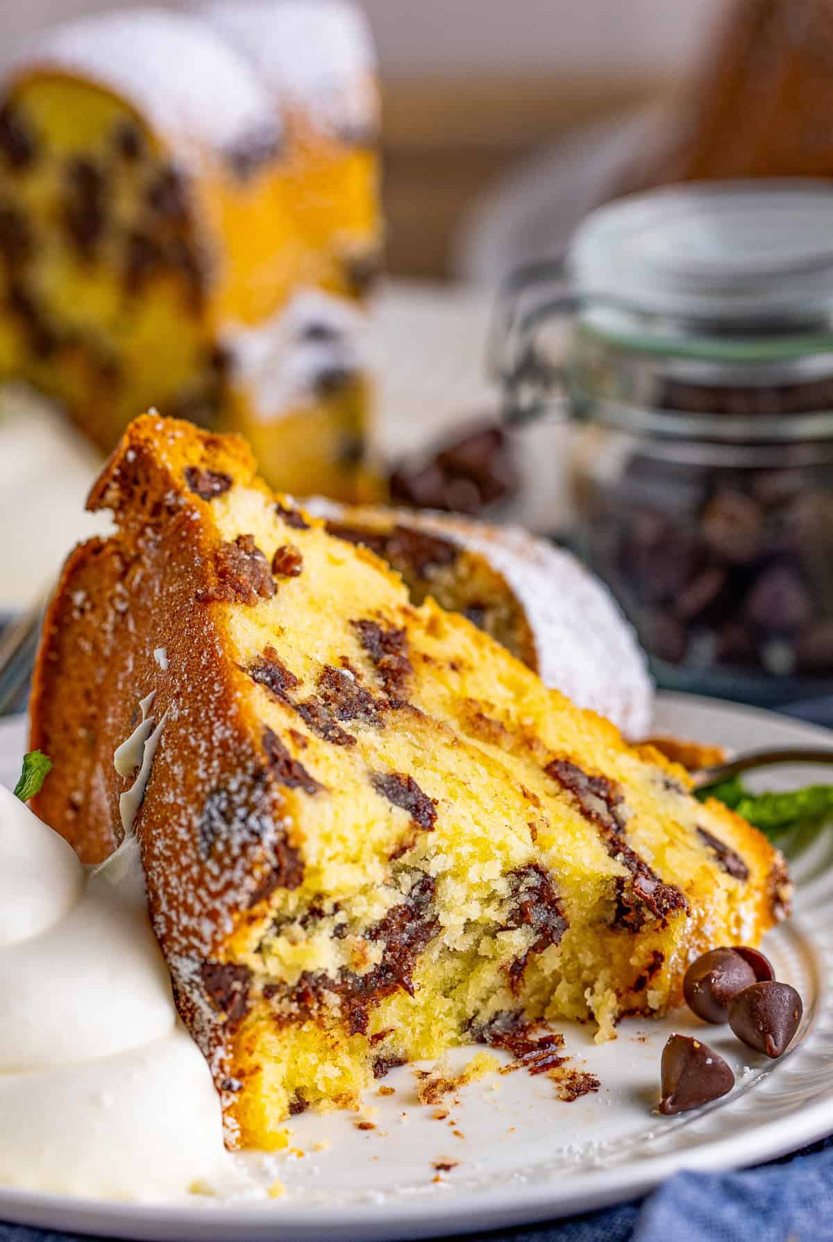 Slice of cake on plate with bite taken out of it.