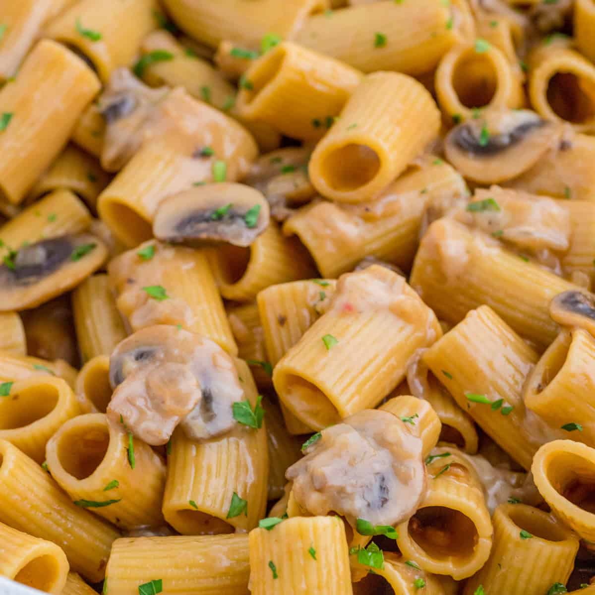 Close up square image of pasta in pan showing all the ingredients.