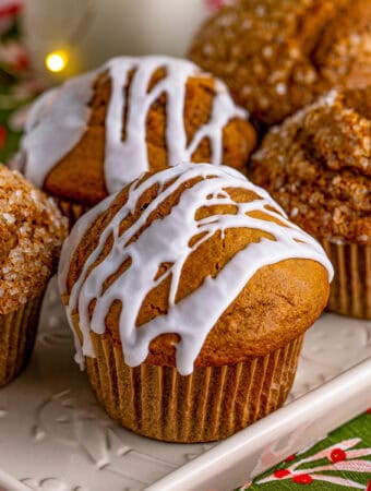 Square image of muffins on white platter.