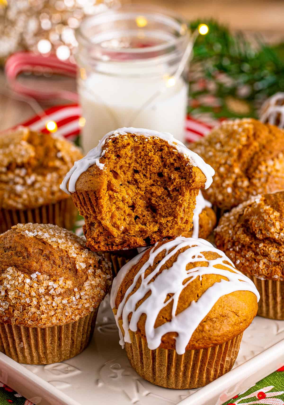 Stacked muffins on white platter with bite taken out of one muffin.