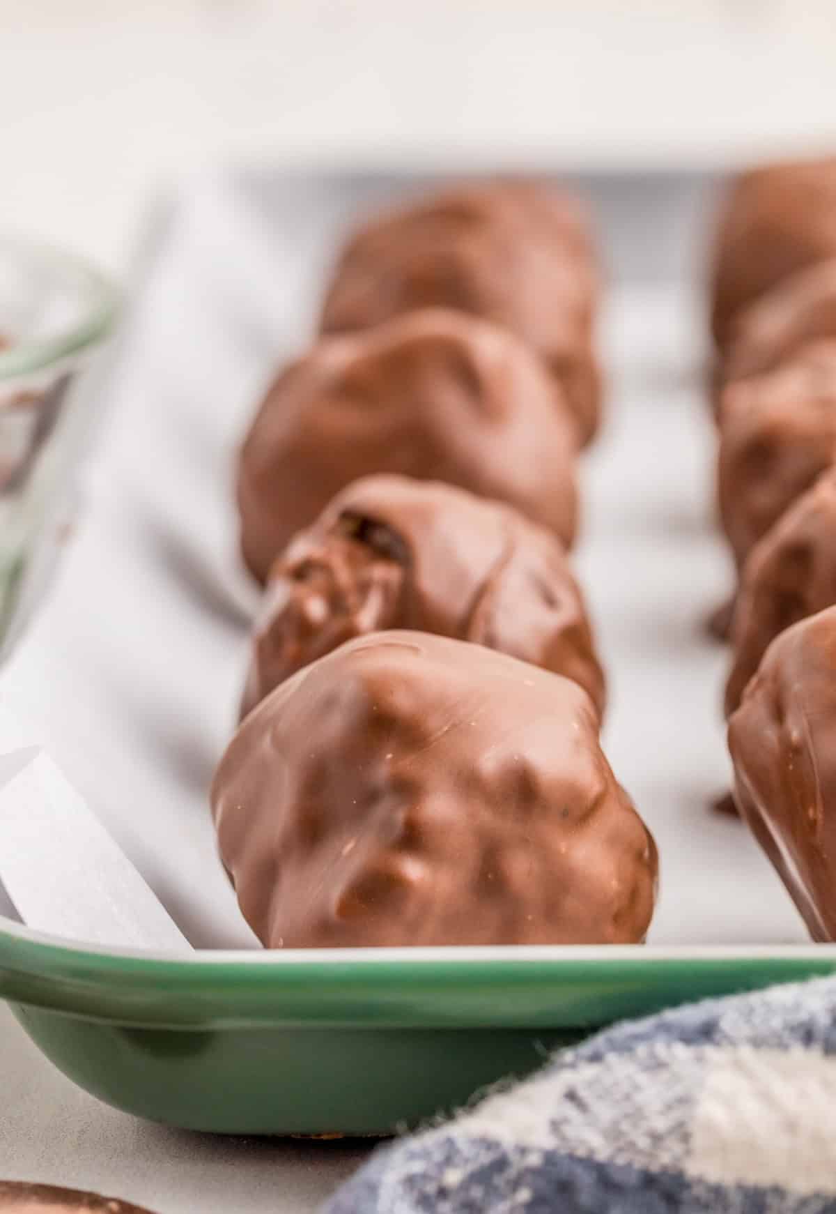 Rice Krispie Peanut Butter Balls finished on parchment paper lined baking sheet.