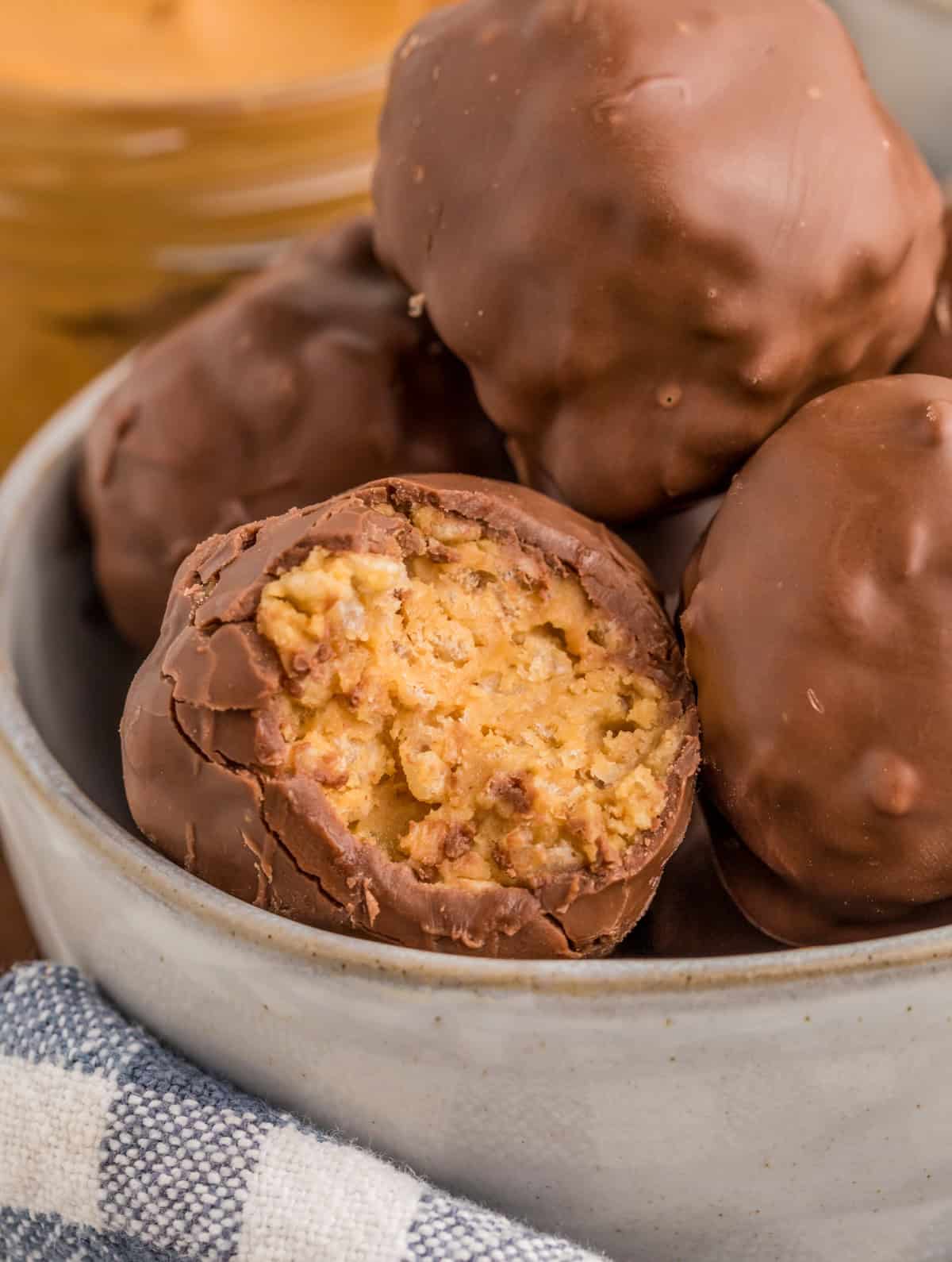 Stacked balls in bowl with close up of bite taken out of one of the balls.