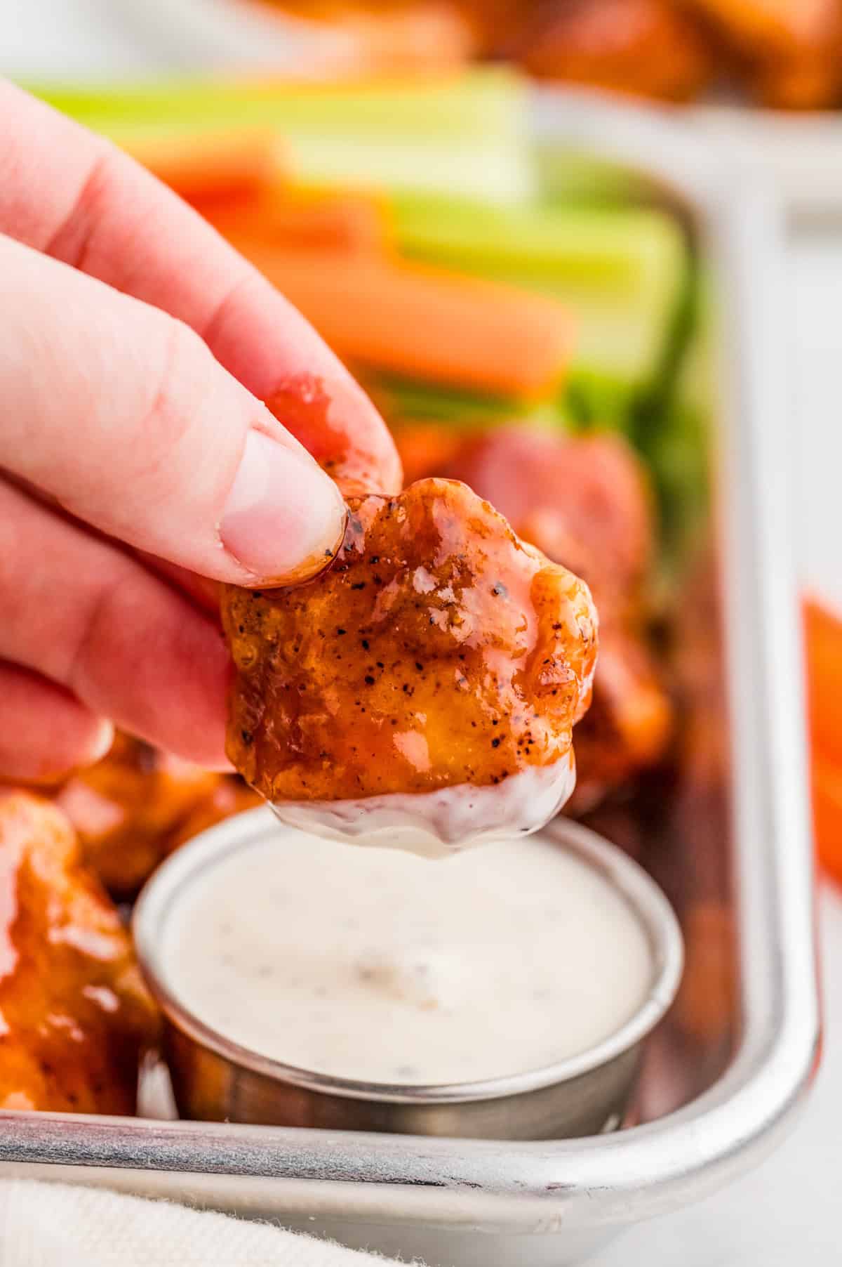 Hand dipping one of the BBQ Chicken Bites into ranch.