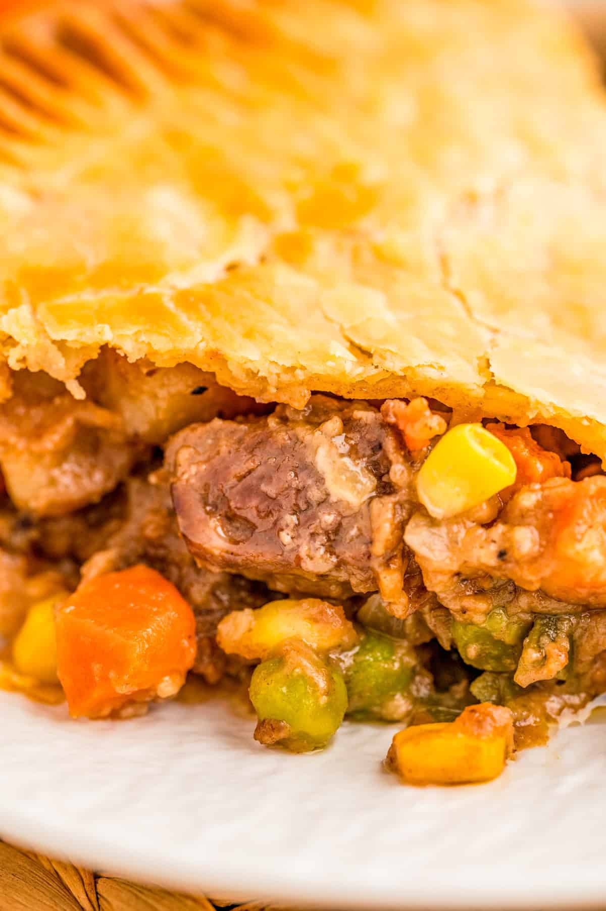 Close up of filing of pie on white plate.