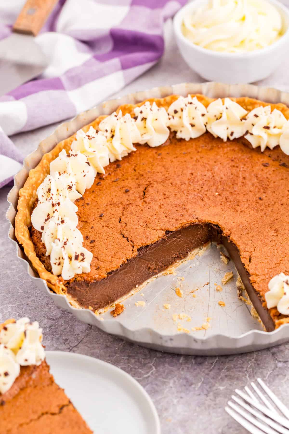 Pie in pie pan topped with garnishes with slices taken out.