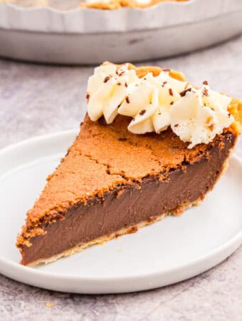 Square image of slice of pie on white plate.