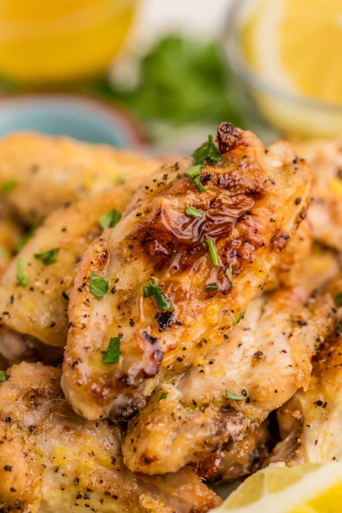 Close up of stacked wings topped with parsley.