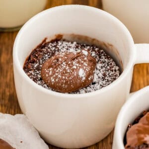 Close up square image of finished cake in white mug.