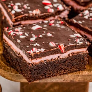 Close up square image of one of the brownies showing the layers and topping.