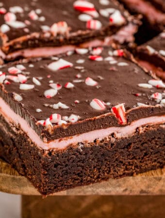 Close up square image of one of the brownies showing the layers and topping.