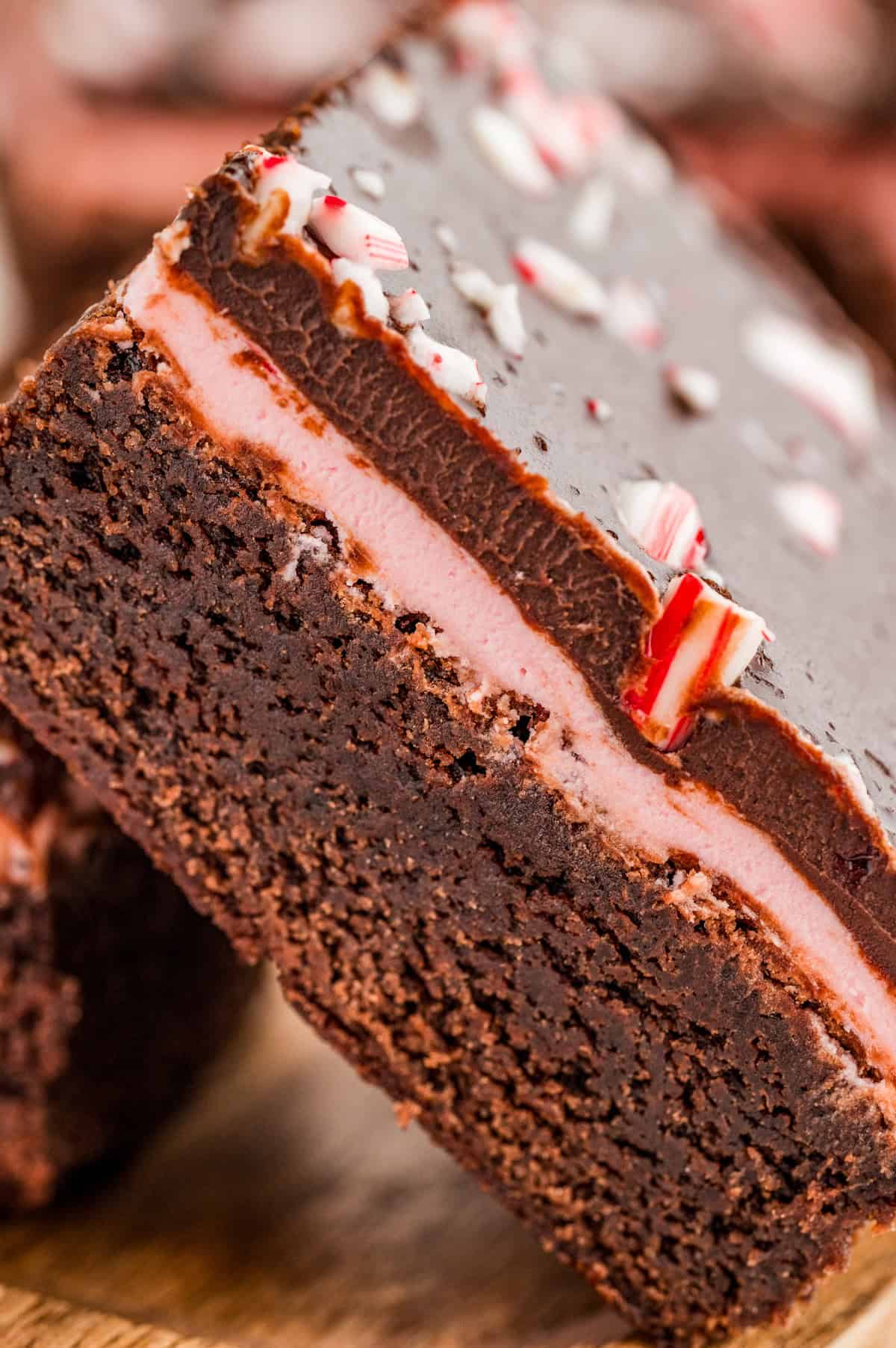 Very close up photo of one brownie at an angle showing the layers.