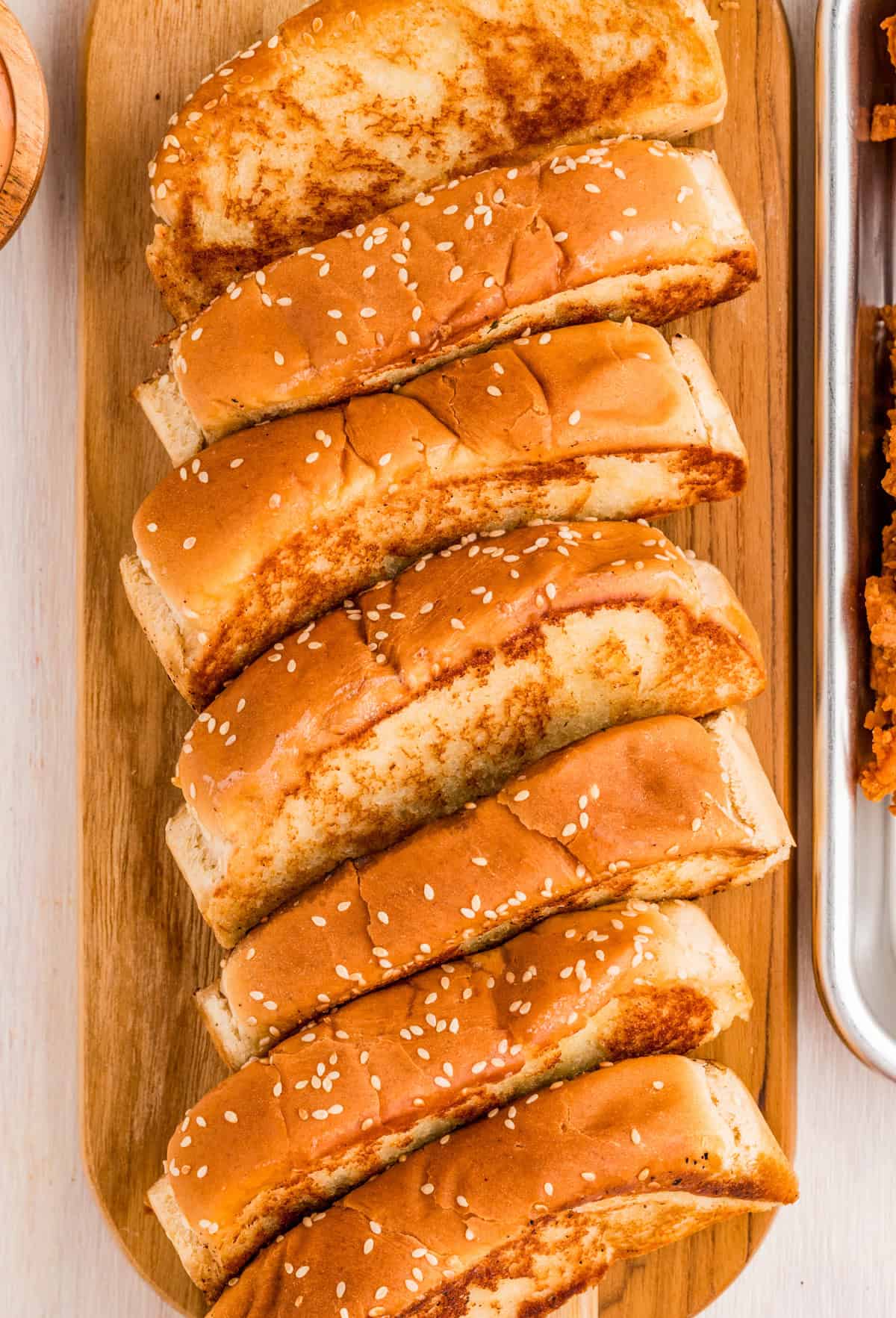 Overhead image of grilled bread on wooden board.