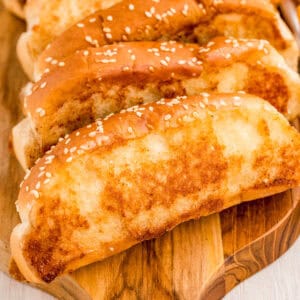 Close up square image of slices of bread leaning against one another on wooden board.