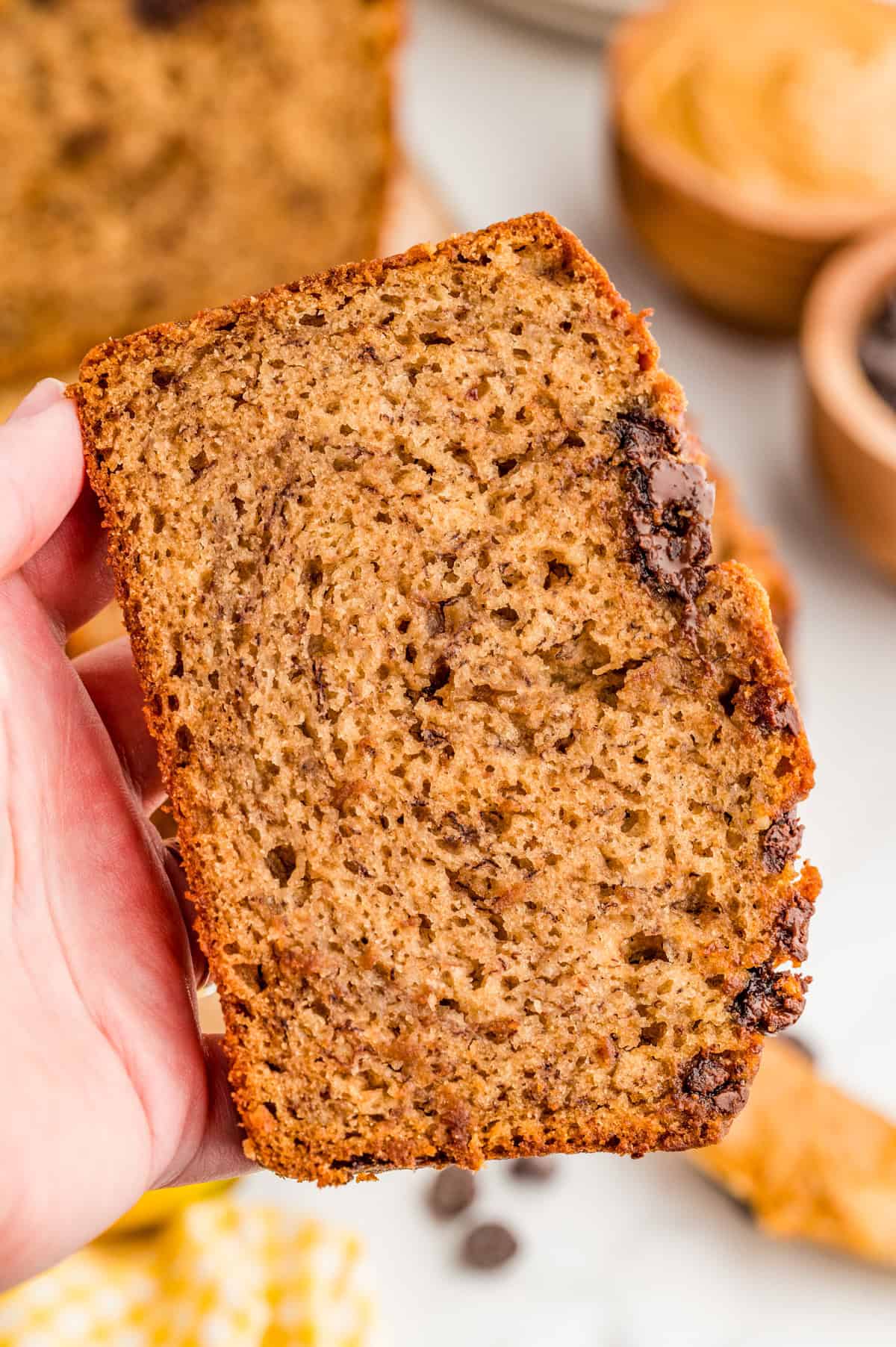 Hand holding up one slice of the bread.