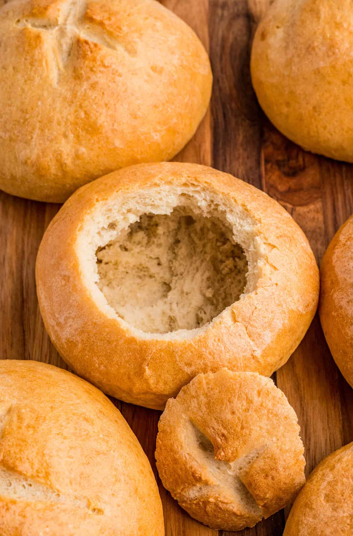 Overhead photo of finished Homemade Bread Bowls with insides taken out of one bowl.