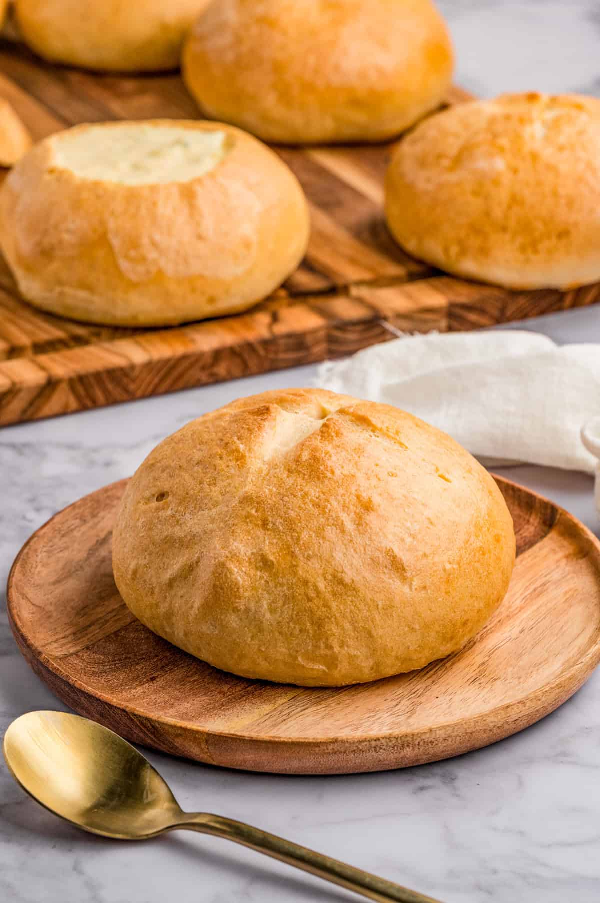 Finished Bread Bowl on wooden plate.