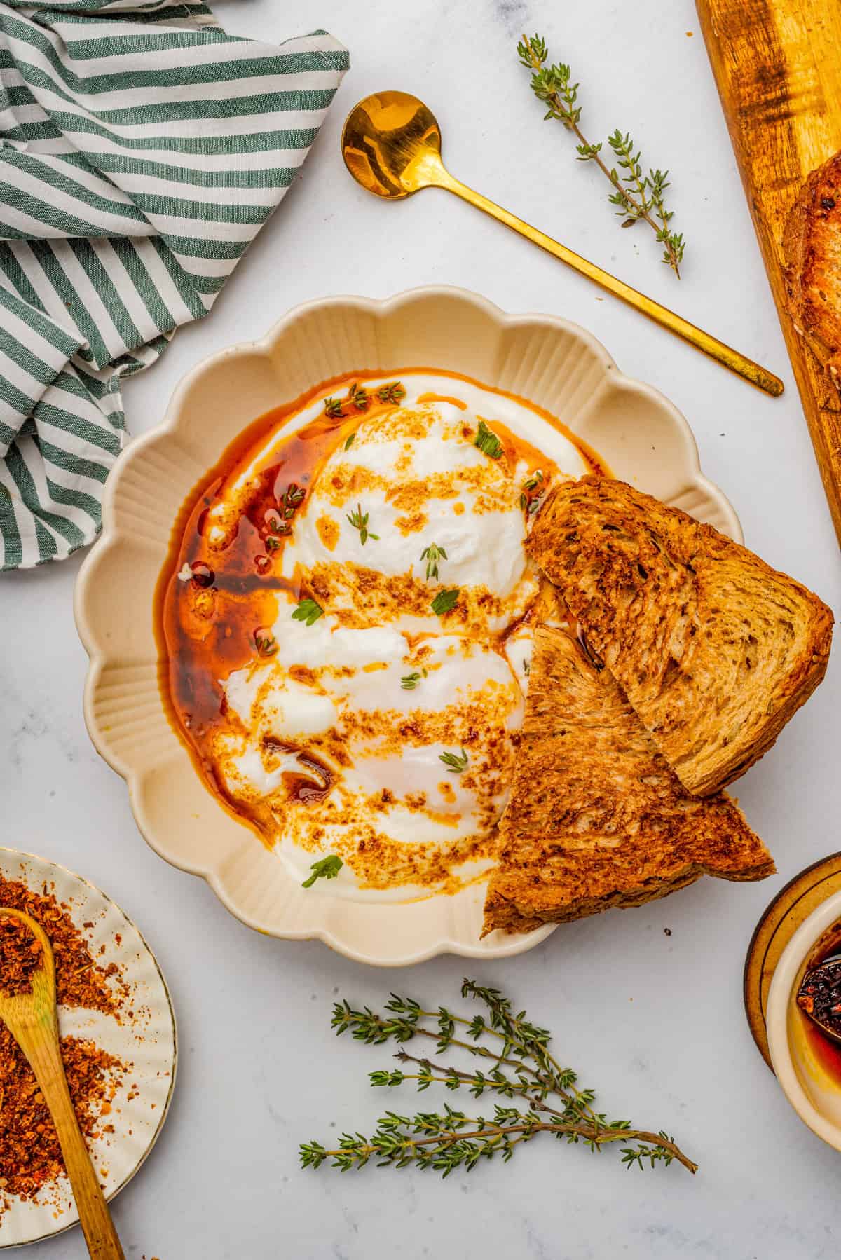 Overhead photo of finished Turkish Eggs garnished with Toast.